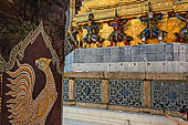 Bangkok Grand Palace, Ramakien murals of the gallery of the Wat Phra Kaew, Nok Samphati the oldest son of Garuda on the background the gilded chedi of the Royal Pantheon. 